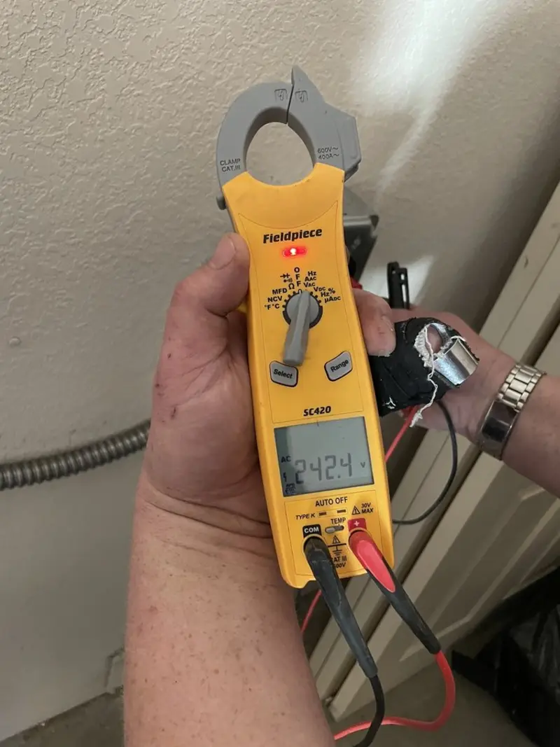 Voltage testing with clamp meter during Whole House Surge Protector in Vestavia Hills